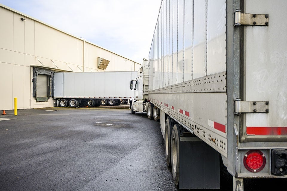 Big rig semi truck with a dry van semi trailer is turning